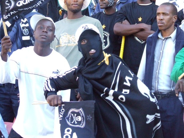 Orlando Pirates supporters in the stands, black and white colours on display